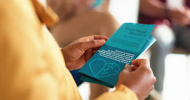 Adult reading a printed health guide at home